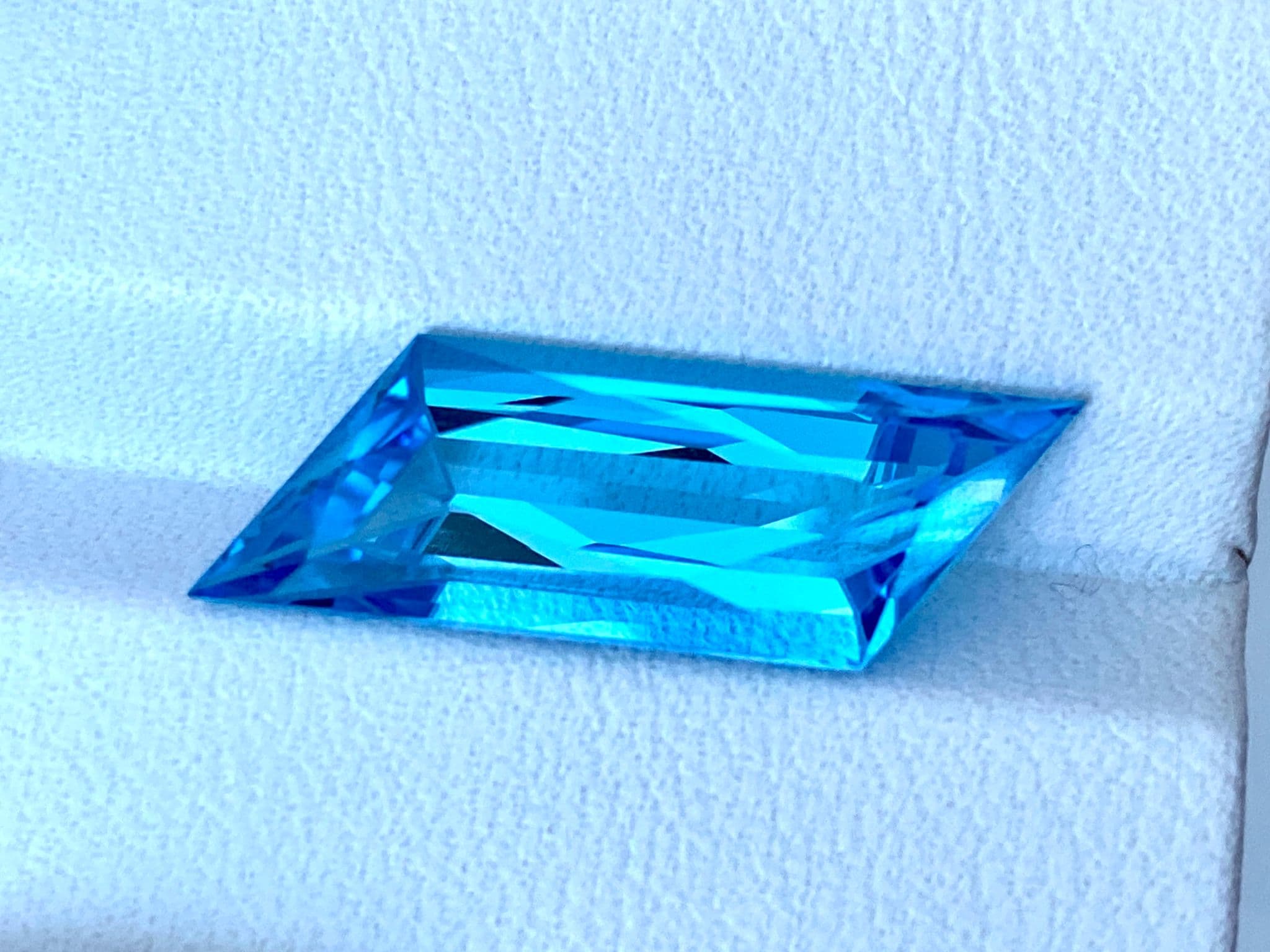 23.50x7.86x6.80mm precision-cut swiss blue topaz facet