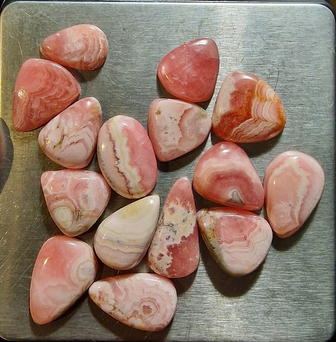 FIFTEEN ring-sized rhodochrosite cabochons