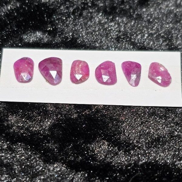 FIVE rose-cut Mozambique ruby cabochons