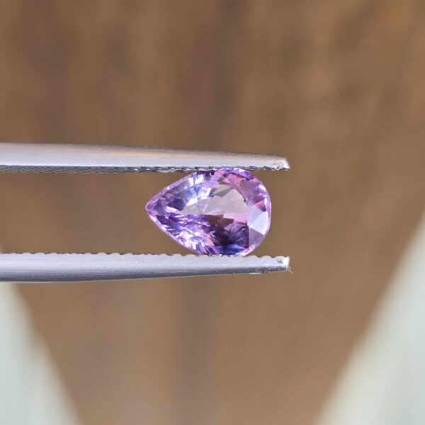 7.77x5.83x3.59mm pear-cut, pinky/purple sapphire facet