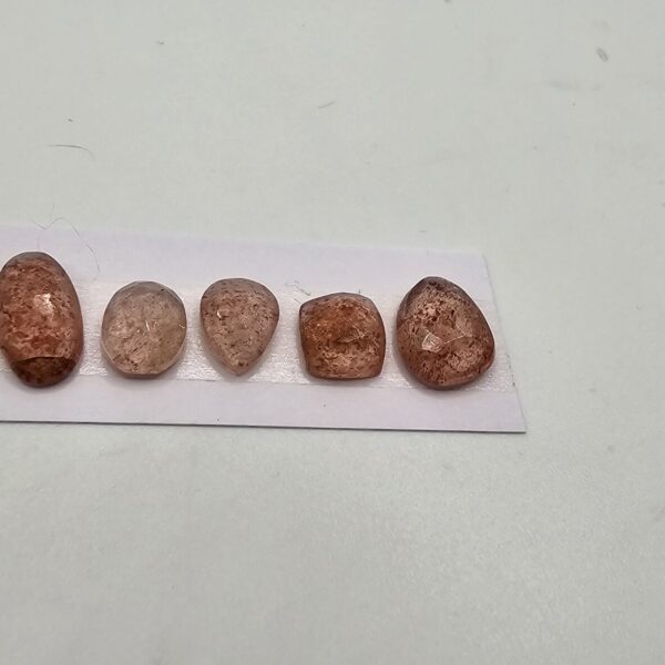 FIVE rose-cut strawberry quartz cabochons