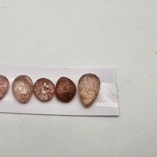 FIVE rose-cut strawberry quartz cabochons