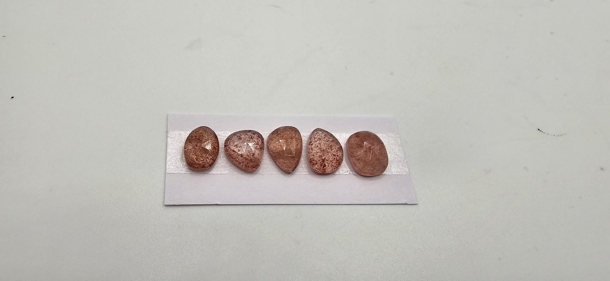 FIVE rose-cut strawberry quartz cabochons