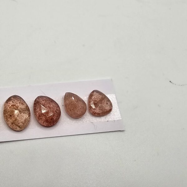 FIVE rose-cut strawberry quartz cabochons