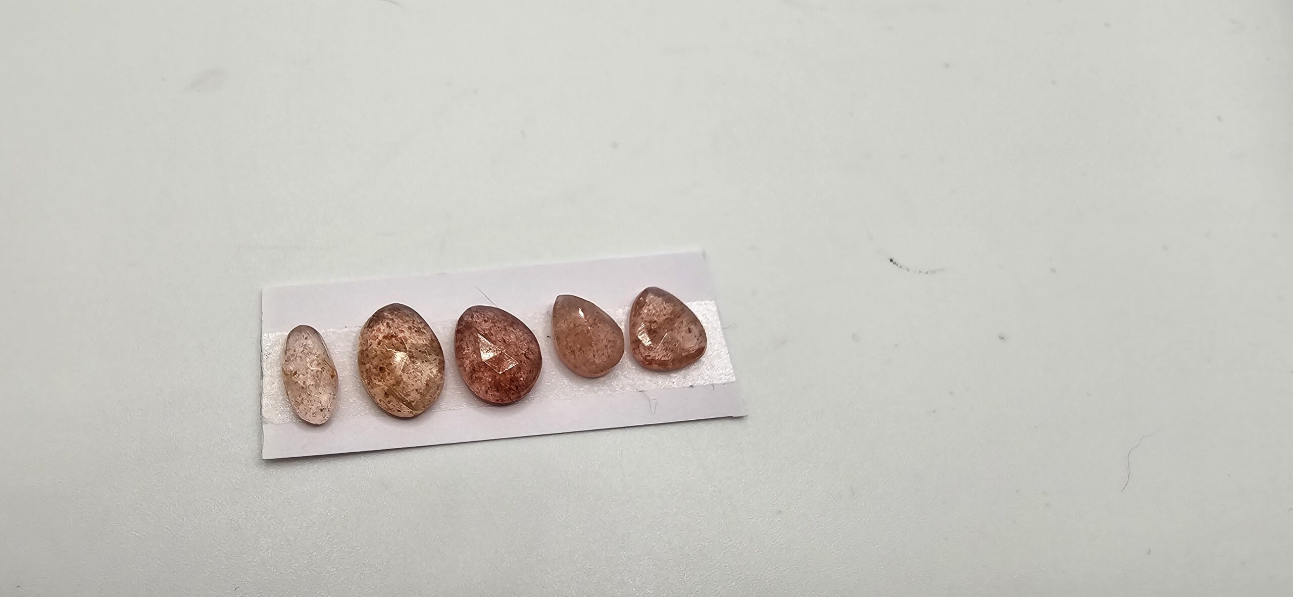 FIVE rose-cut strawberry quartz cabochons