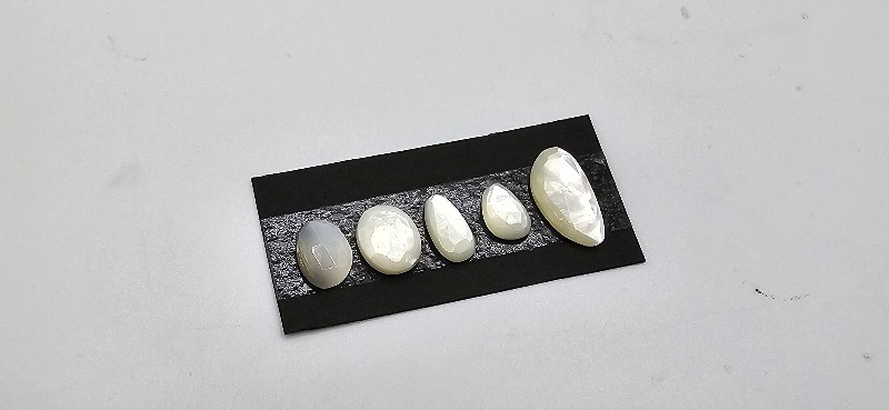 FIVE rose-cut mother of pearl cabochons