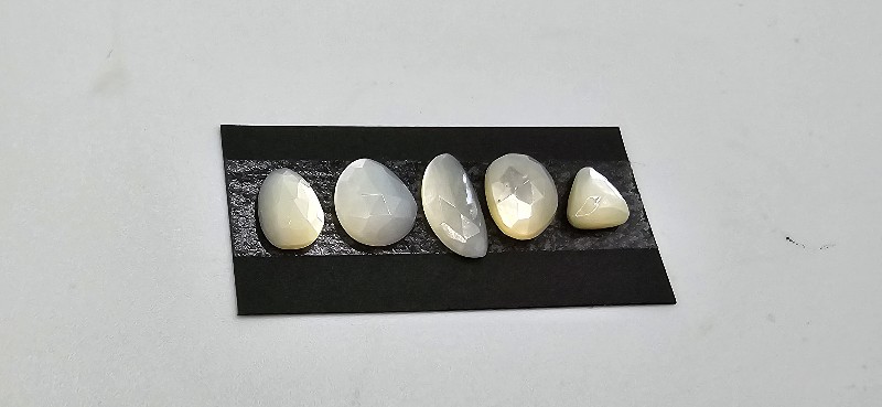 FIVE rose-cut mother of pearl cabochons