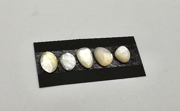 FIVE rose-cut mother of pearl cabochons