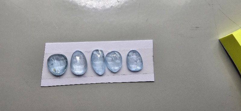 FIVE rose-cut sky blue topaz cabochons