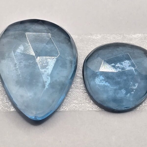 FOUR rose-cut London blue topaz cabochons