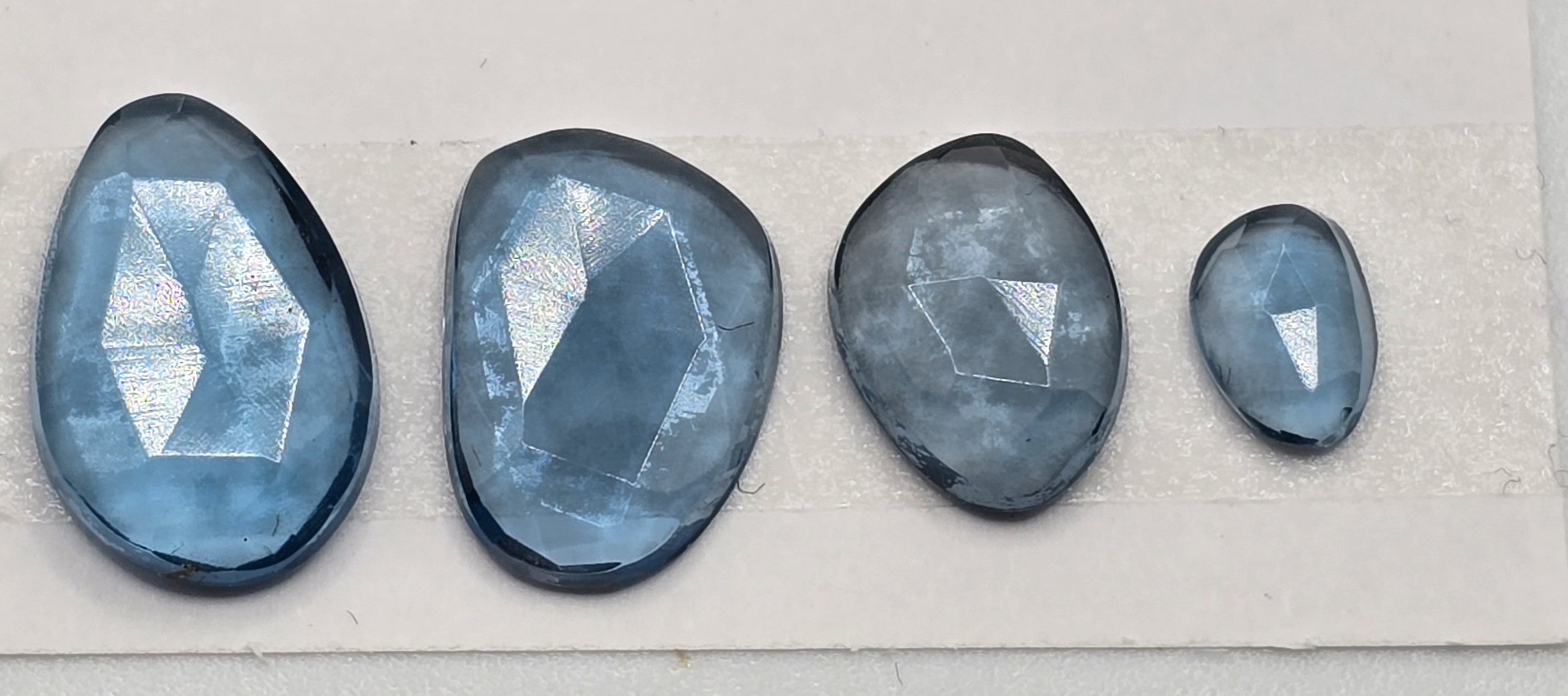 FOUR rose-cut London blue topaz cabochons