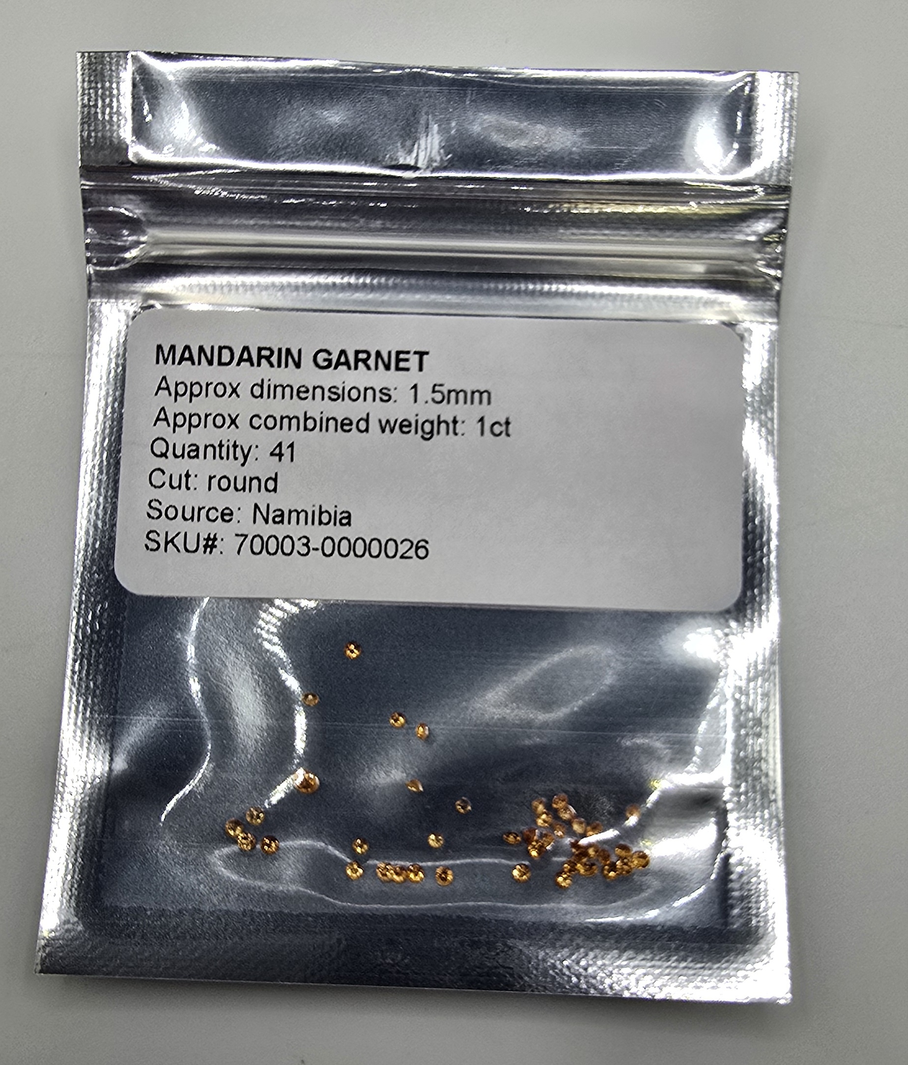 1ct parcel of 1.5mm round Mandarin garnet facets